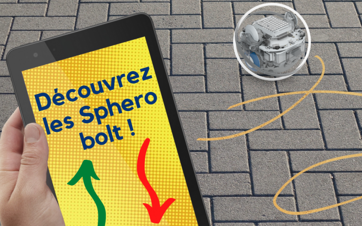 Accéder à l'événement "Atelier Sphero Bolts : Défi Jeux Olympiques". En premier plan, une main tenant une tablette. Texte sur la tablette : "Découvrez les Sphéro Bolts !". En arrière plan : un Sphéro Bolt en en train de rouler.